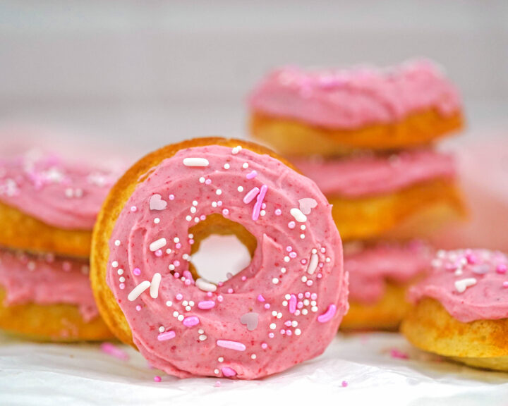 baked mini donuts with strawberry frosting and pink sprinkles